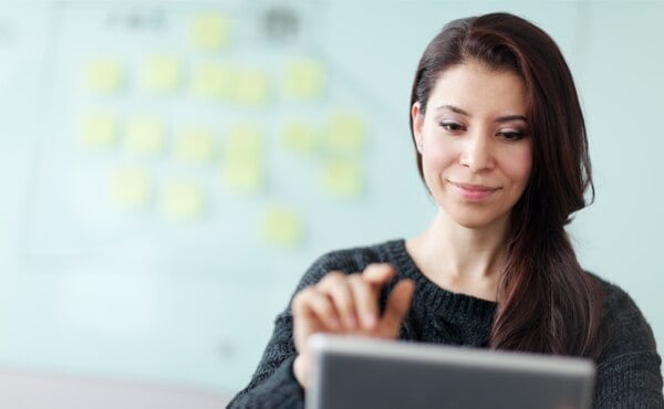 woman on tablet smiling