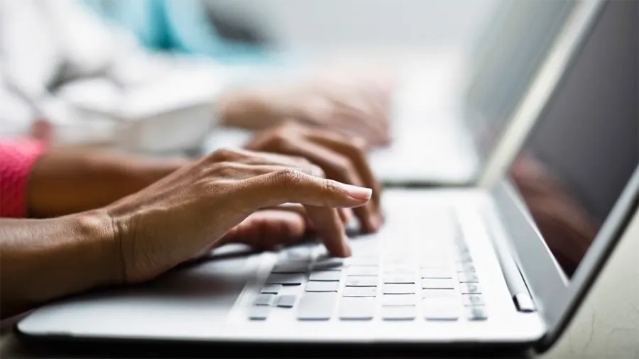 hands on a laptop