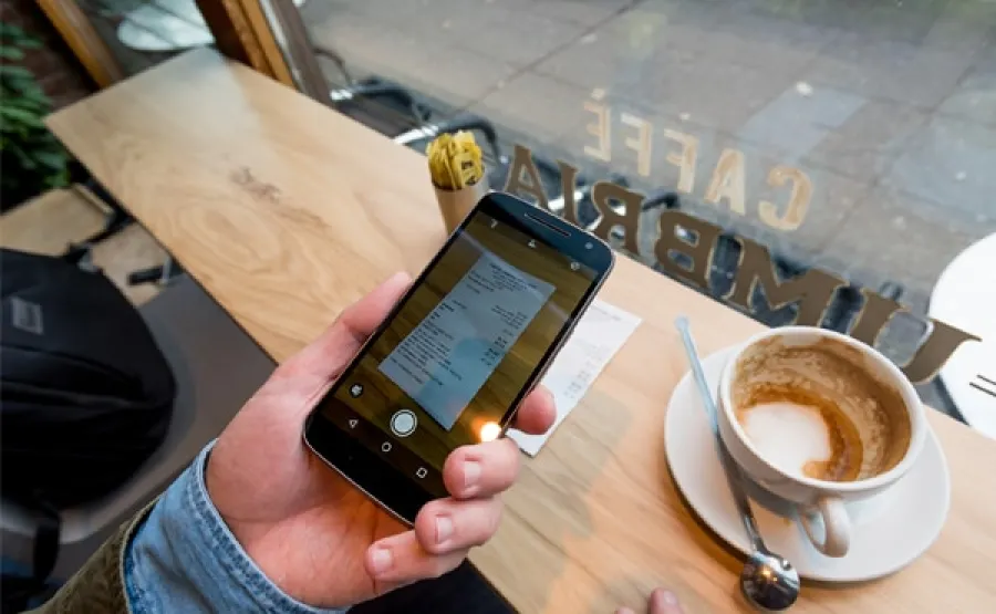 Photo of receipt being taken with phone
